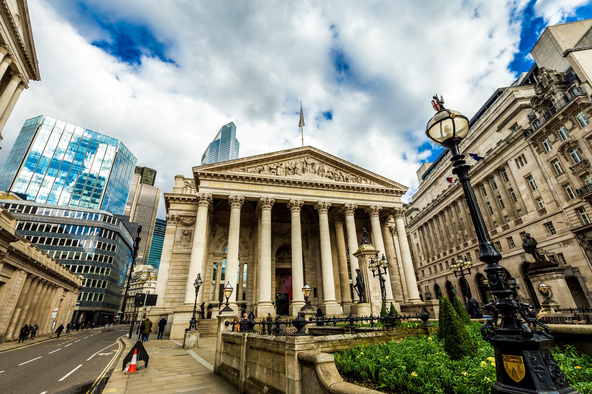 People walking on city street outside Bank of England, London, UK